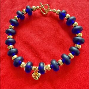 Lapis lazuli glass beaded bracelet,14K gold plated spacers.Toggle clasp.7.75”
